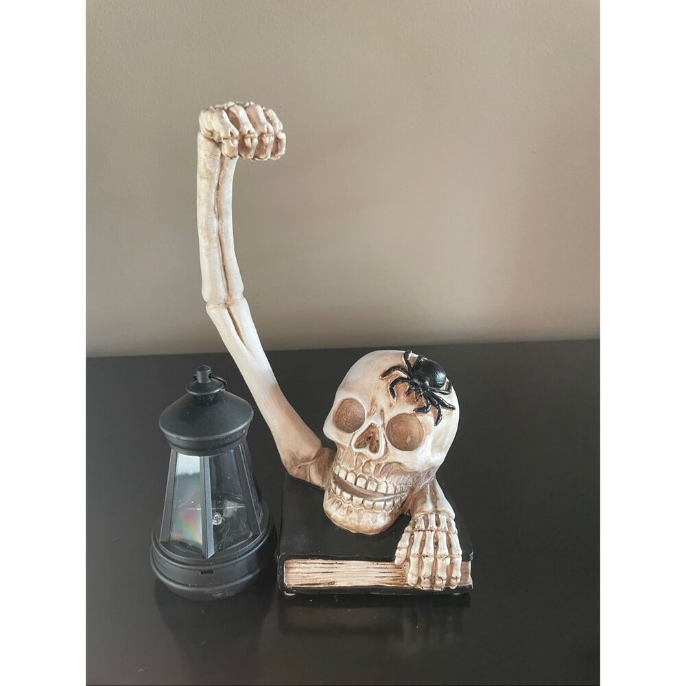 Flawed Halloween skeleton skull holding solar powered lantern home decoration